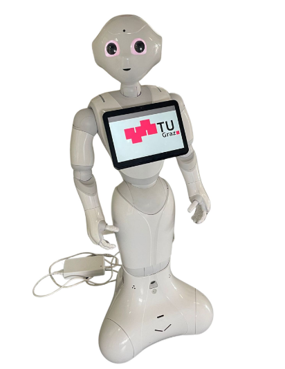 Ein wei&szlig;er Roboter. Auf der Brust tr&auml;gt der Roboter einen Bildschirm mit dem TU Graz Logo.